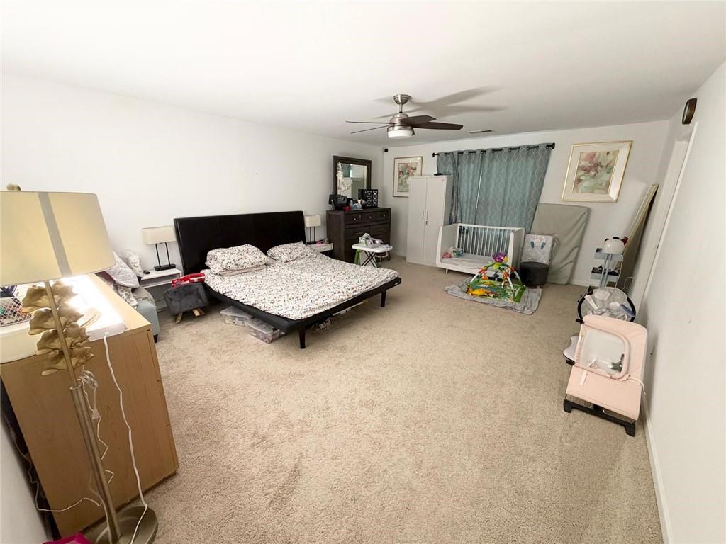 5790 Flint Lane Cumming, GA 30028 - Photo 24 of 40 a living room with furniture and a flat screen tv
