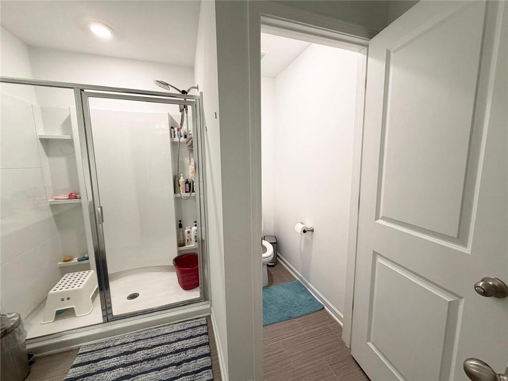 5790 Flint Lane Cumming, GA 30028 - Photo 26 of 40 a bathroom with a shower and a mirror