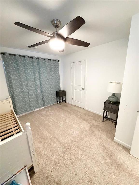 5790 Flint Lane Cumming, GA 30028 - Photo 32 of 40 a bedroom with a bed and a chandelier