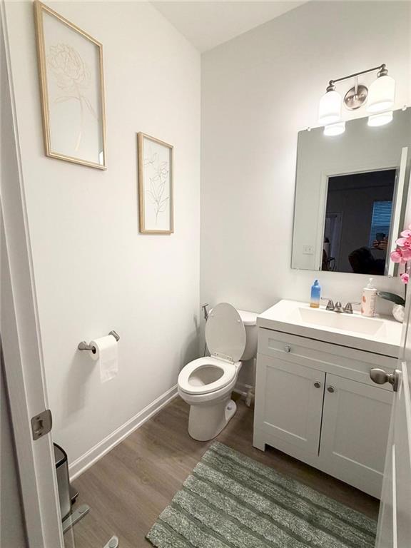 5790 Flint Lane Cumming, GA 30028 - Photo 37 of 40 a bathroom with a toilet sink and mirror