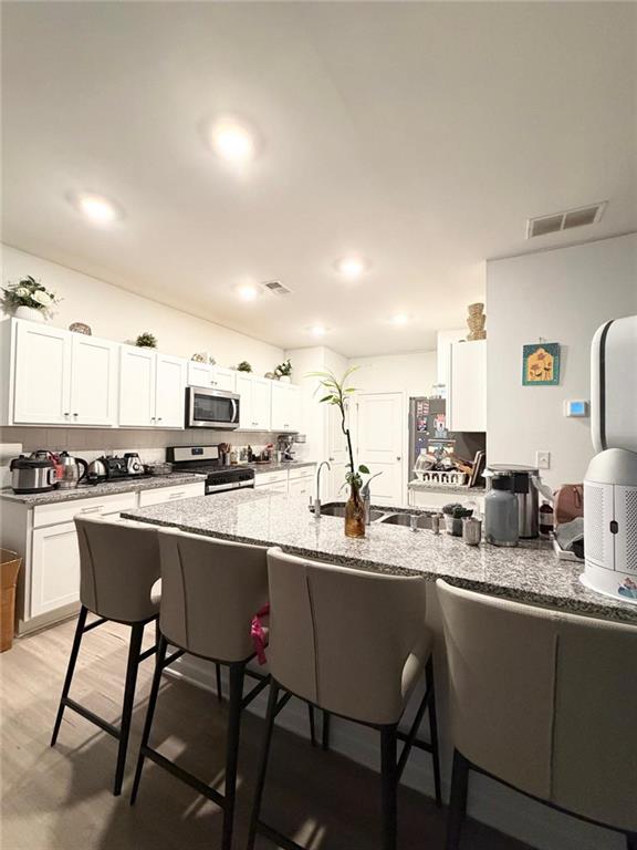 5790 Flint Lane Cumming, GA 30028 - Photo 10 of 40 a kitchen with a sink and chairs