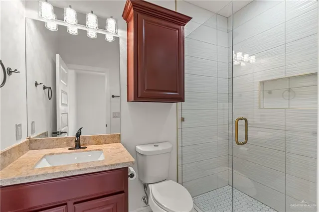 a bathroom with a sink toilet and shower