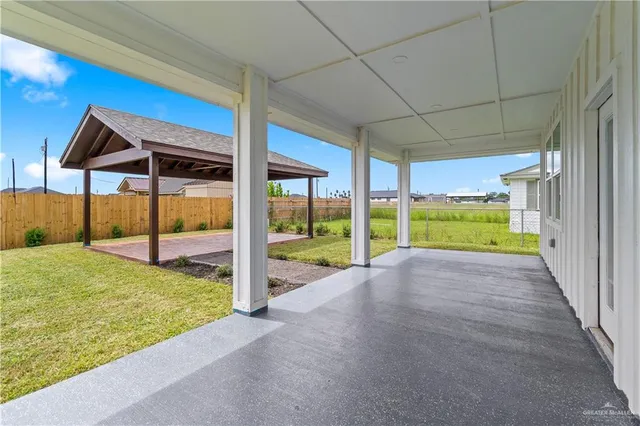 a backyard of a house with table and chairs