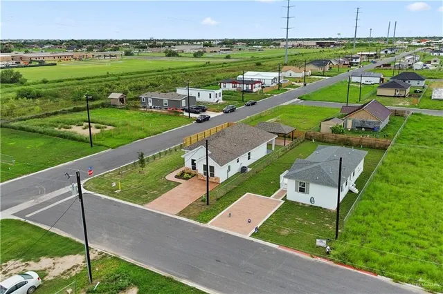 an aerial view of a house with a yard and lake view