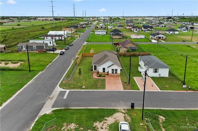 an aerial view of a house with outdoor space lake view and mountain view