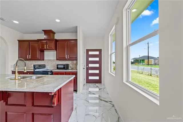 a kitchen with a stove a sink and a refrigerator