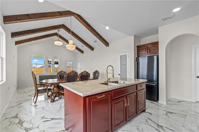 a dining hall with stainless steel appliances granite countertop a granite counter tops and a view of living room