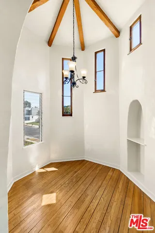 a view of a room with wooden floor and workspace