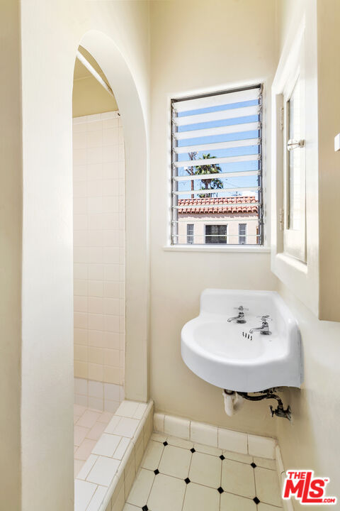 8221 West 4th Street Los Angeles, CA 90048 - Photo 17 of 21 a bathroom with a sink and a mirror