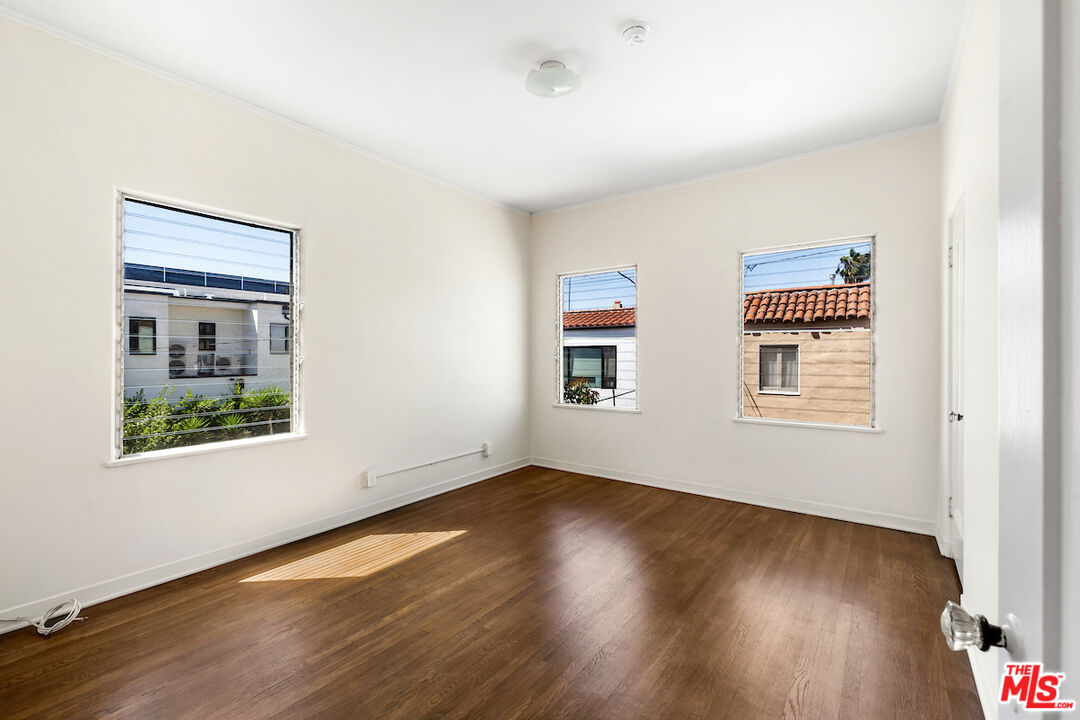 8221 West 4th Street Los Angeles, CA 90048 - Photo 18 of 21 a view of an empty room with wooden floor and a window