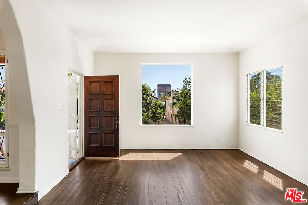 8221 West 4th Street Los Angeles, CA 90048 - Photo 4 of 21 an empty room with wooden floor and windows