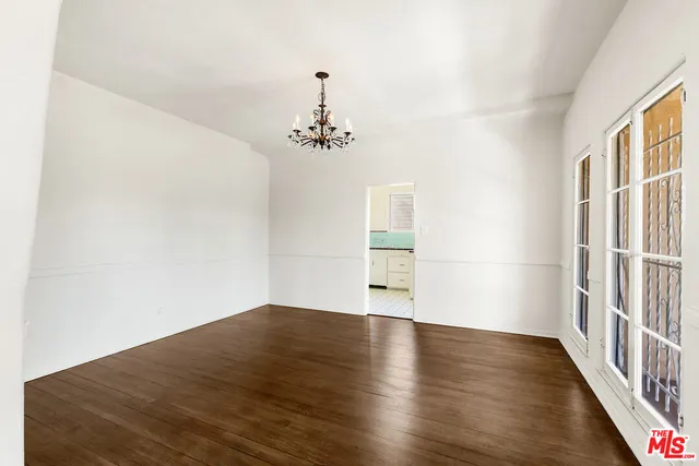 a big room with wooden floor and windows