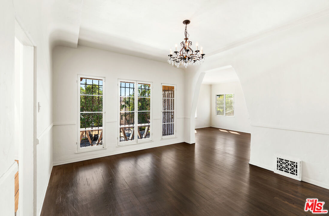 8221 West 4th Street Los Angeles, CA 90048 - Photo 10 of 21 a view of an empty room with wooden floor and a window