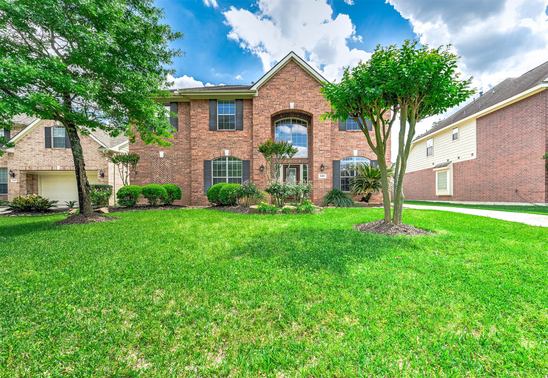 a front view of house with yard and green space