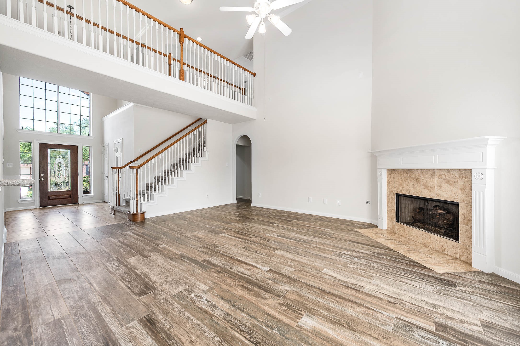 6411 Greencreek Meadows Lane Spring, TX 77379 - Photo 11 of 39 a view of an empty room with wooden floor and a fireplace