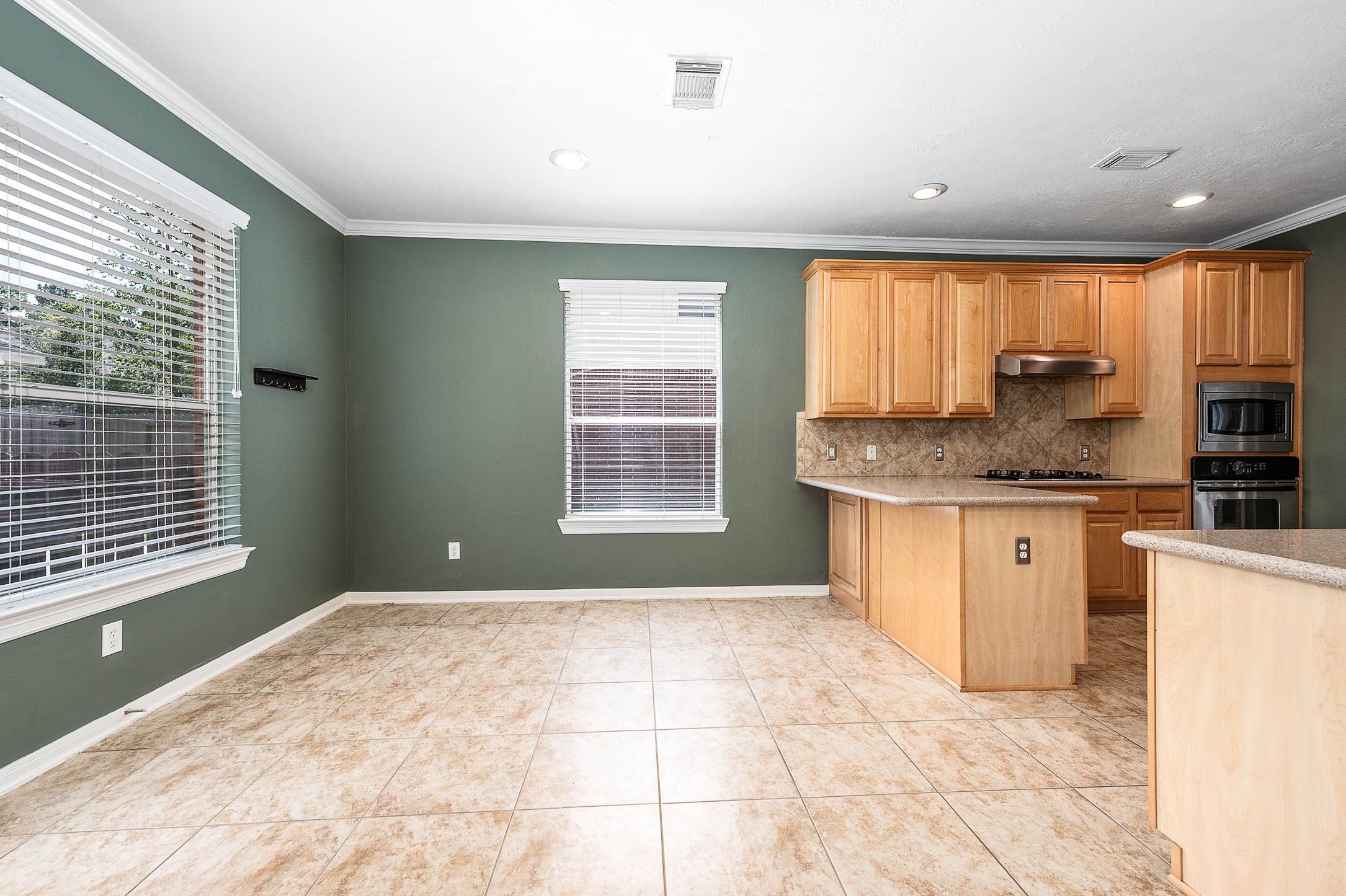 6411 Greencreek Meadows Lane Spring, TX 77379 - Photo 12 of 39 a kitchen with stainless steel appliances granite countertop a sink a stove a cabinets a window and a refrigerator