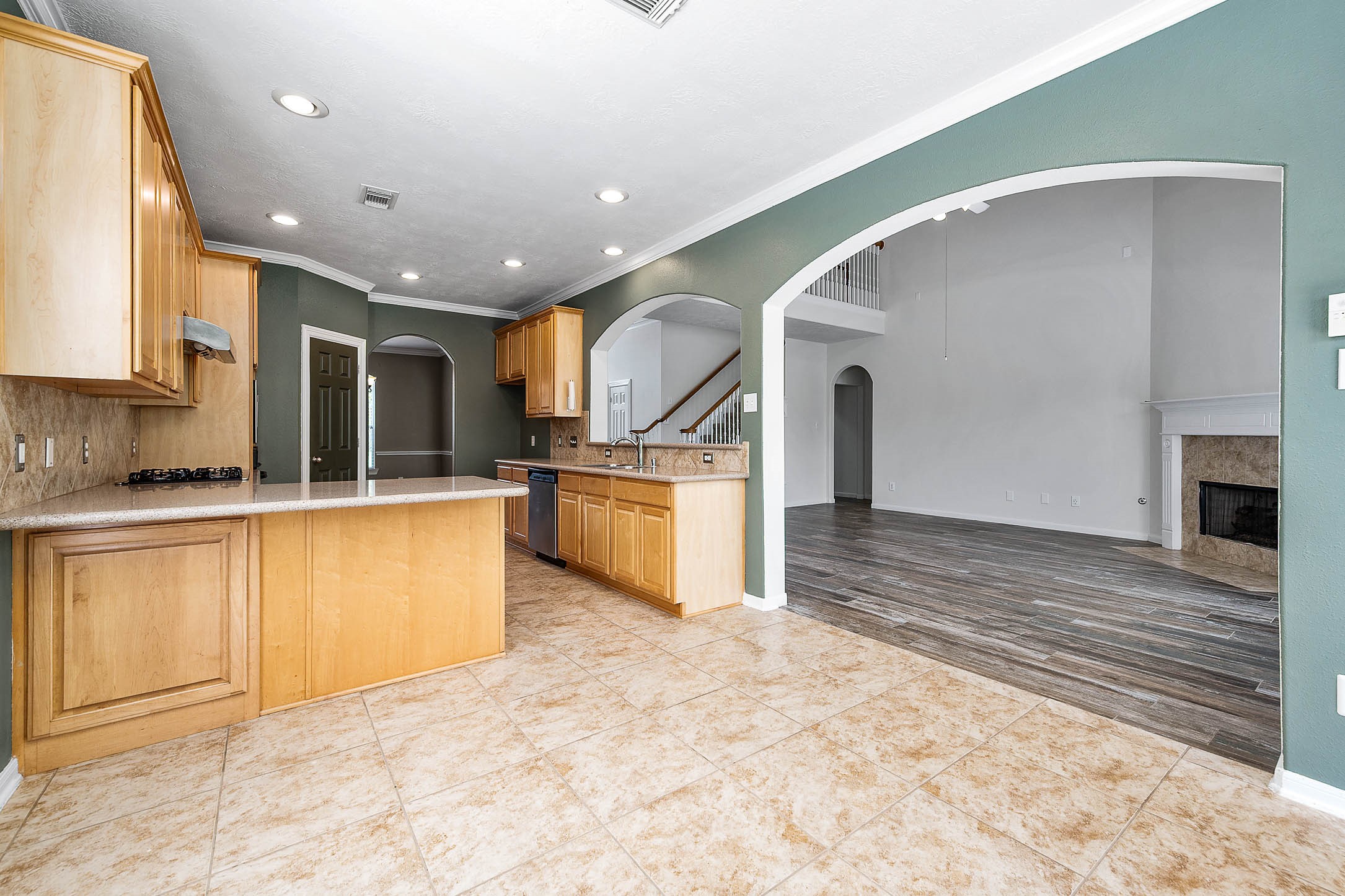 6411 Greencreek Meadows Lane Spring, TX 77379 - Photo 15 of 39 a large kitchen with stainless steel appliances granite countertop a stove and a sink