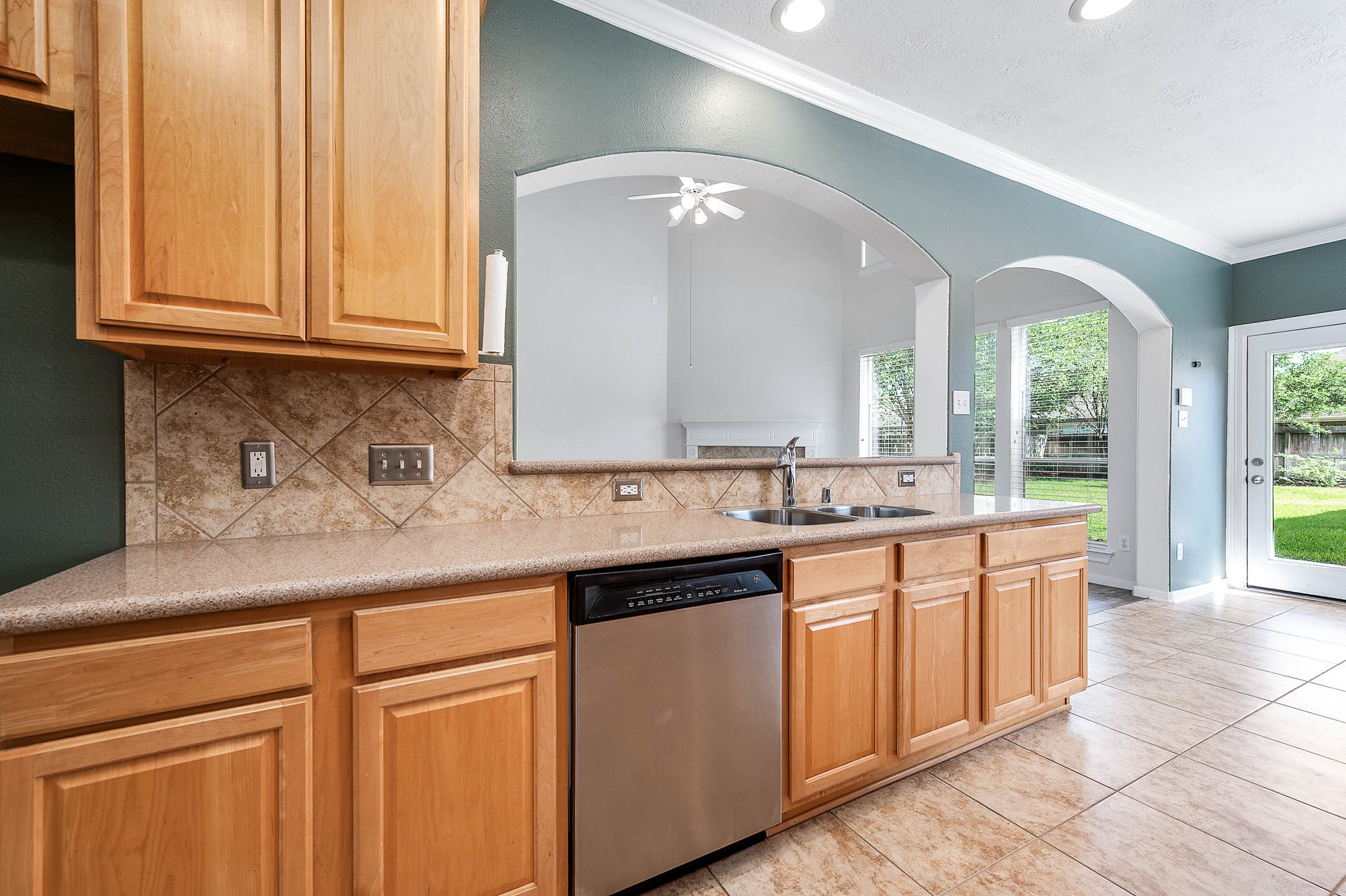 6411 Greencreek Meadows Lane Spring, TX 77379 - Photo 18 of 39 a kitchen with stainless steel appliances granite countertop a sink and cabinets with wooden floor