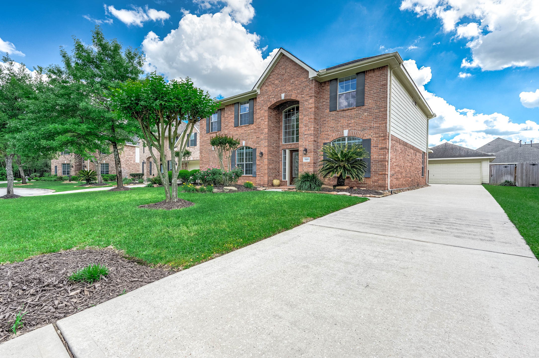 6411 Greencreek Meadows Lane Spring, TX 77379 - Photo 2 of 39 a front view of house with yard and green space