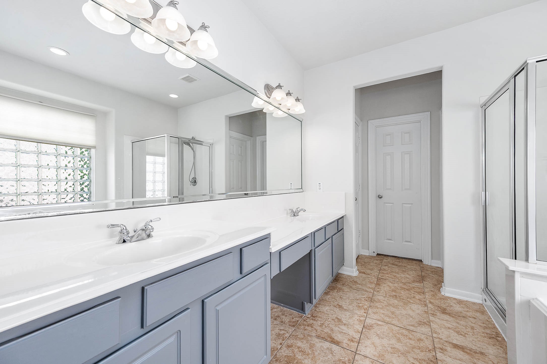 6411 Greencreek Meadows Lane Spring, TX 77379 - Photo 22 of 39 a spacious bathroom with a granite countertop sink a mirror and a bathtub