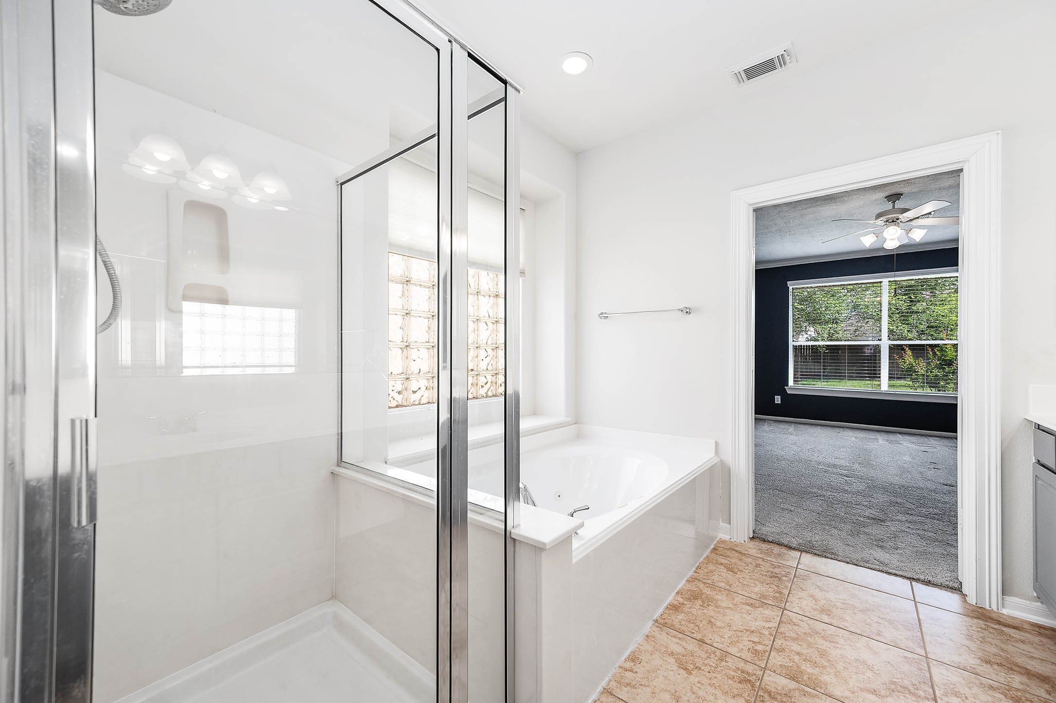 6411 Greencreek Meadows Lane Spring, TX 77379 - Photo 23 of 39 a bathroom with a bathtub and a shower