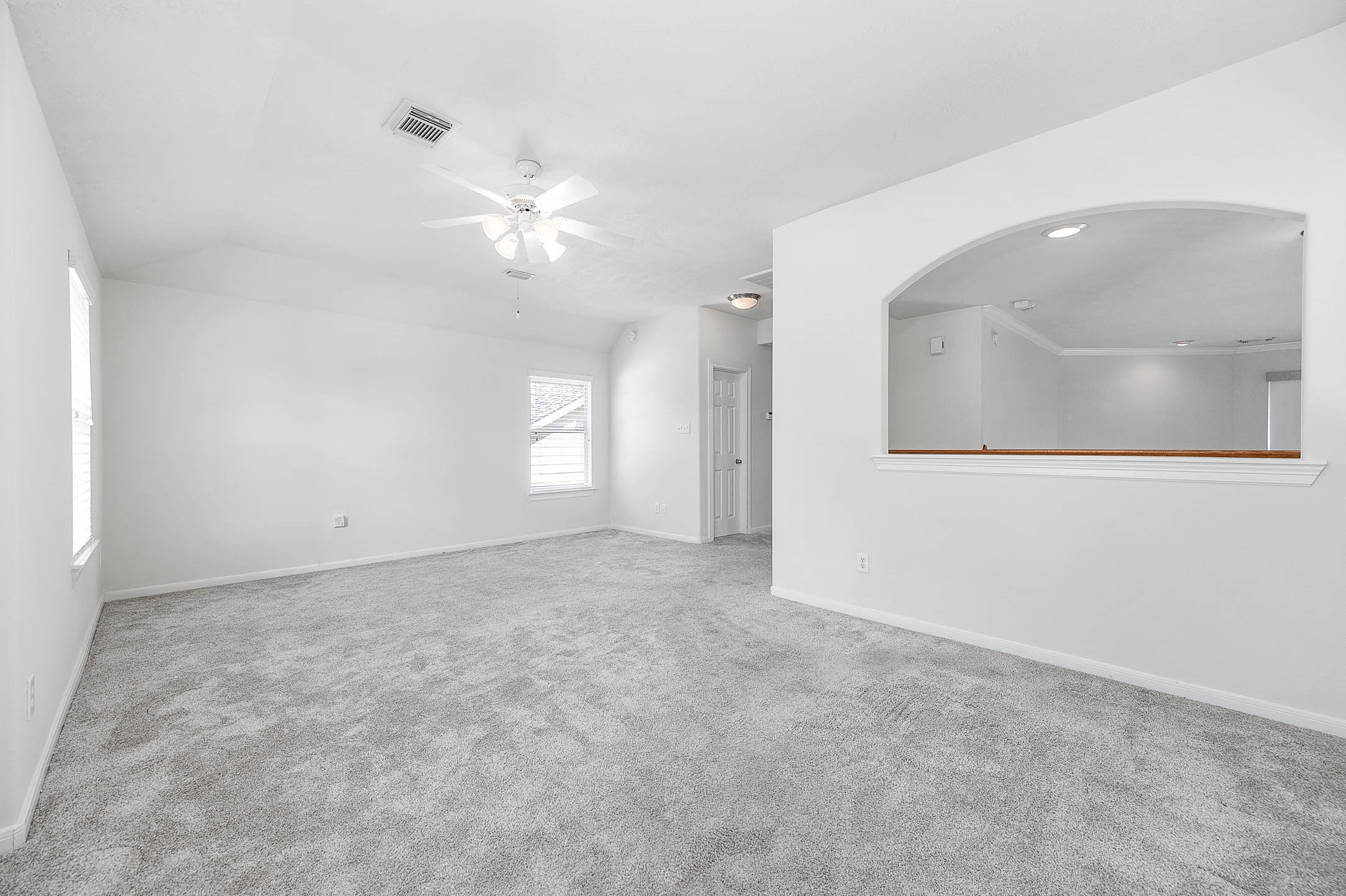 6411 Greencreek Meadows Lane Spring, TX 77379 - Photo 28 of 39 en empty room with windows and fan