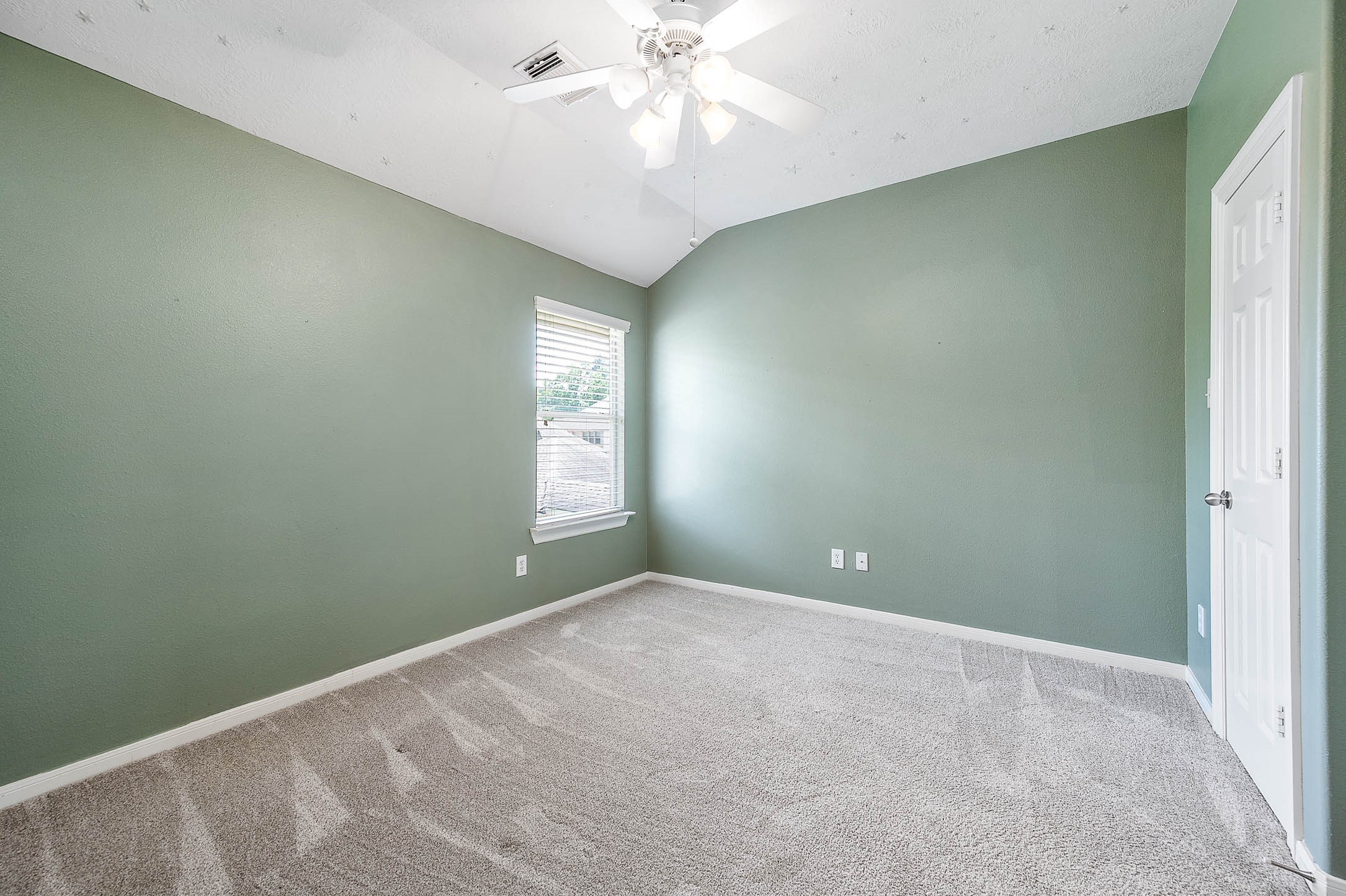 6411 Greencreek Meadows Lane Spring, TX 77379 - Photo 30 of 39 an empty room with windows and chandelier fan