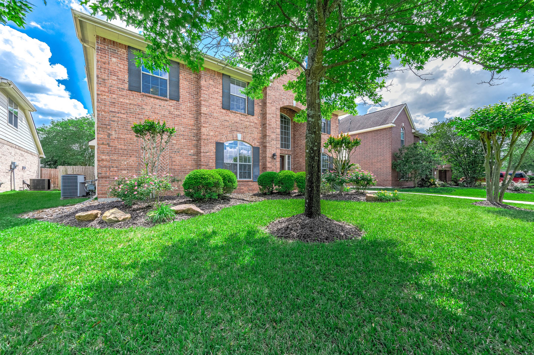 6411 Greencreek Meadows Lane Spring, TX 77379 - Photo 3 of 39 a view of a garden with a house in the background