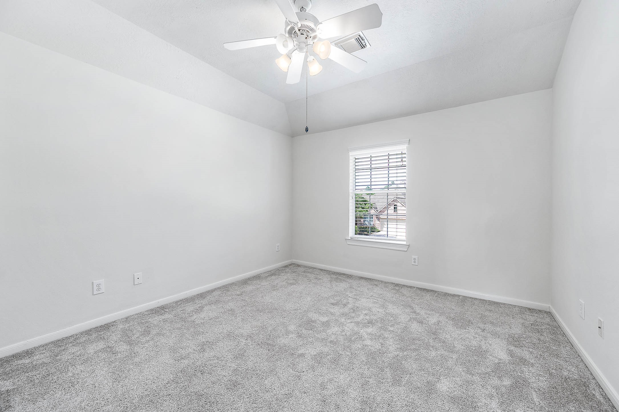 6411 Greencreek Meadows Lane Spring, TX 77379 - Photo 31 of 39 an empty room with a window and a ceiling fan