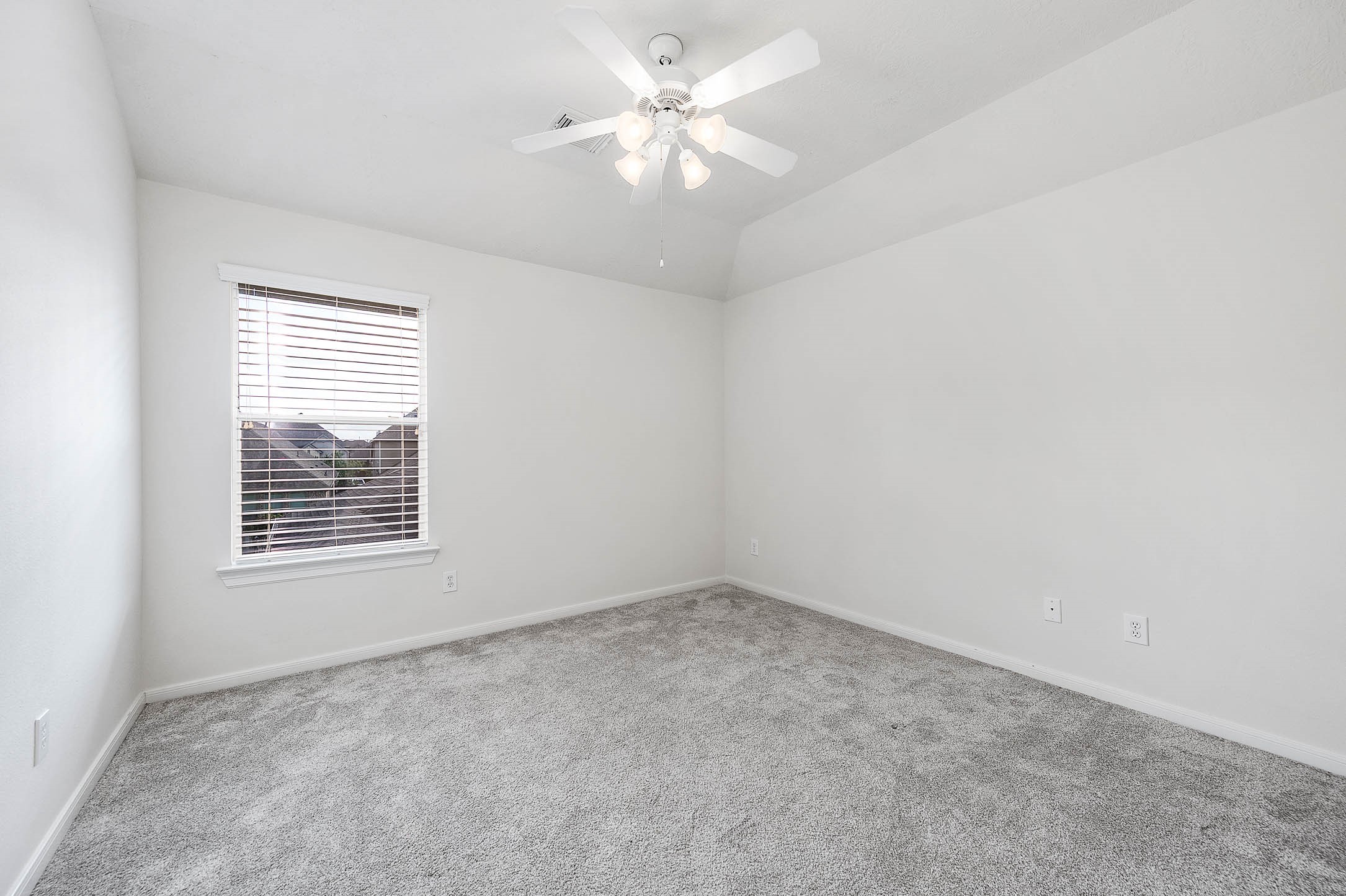 6411 Greencreek Meadows Lane Spring, TX 77379 - Photo 33 of 39 an empty room with a window and a ceiling fan