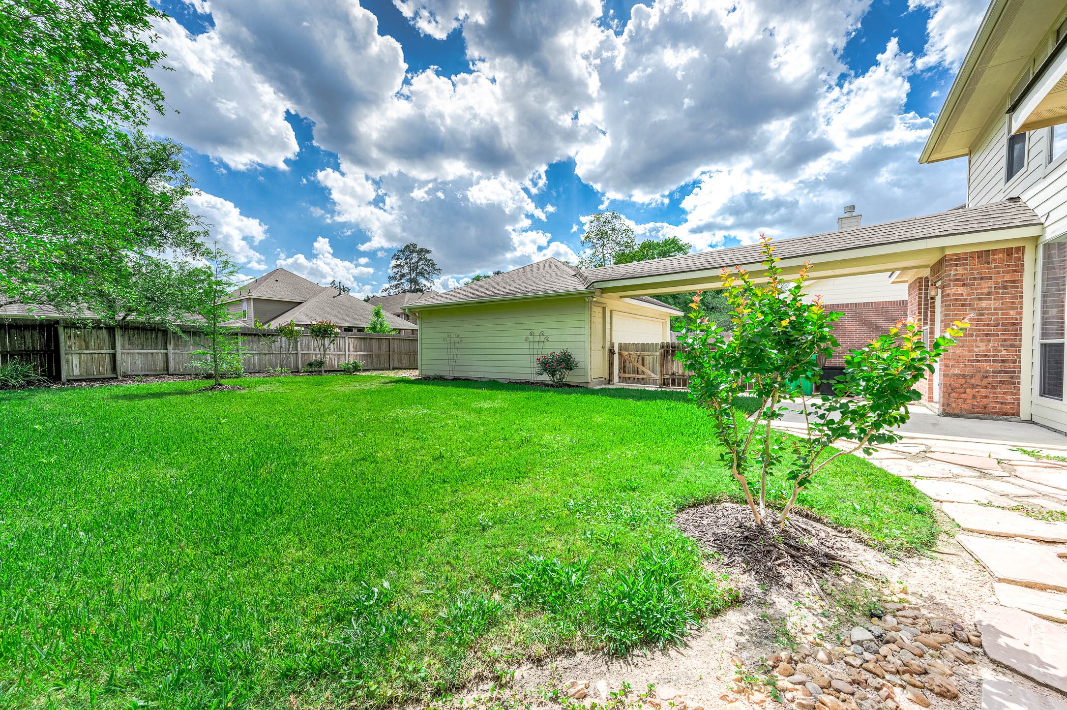 6411 Greencreek Meadows Lane Spring, TX 77379 - Photo 37 of 39 a view of a house with a big yard and a large tree