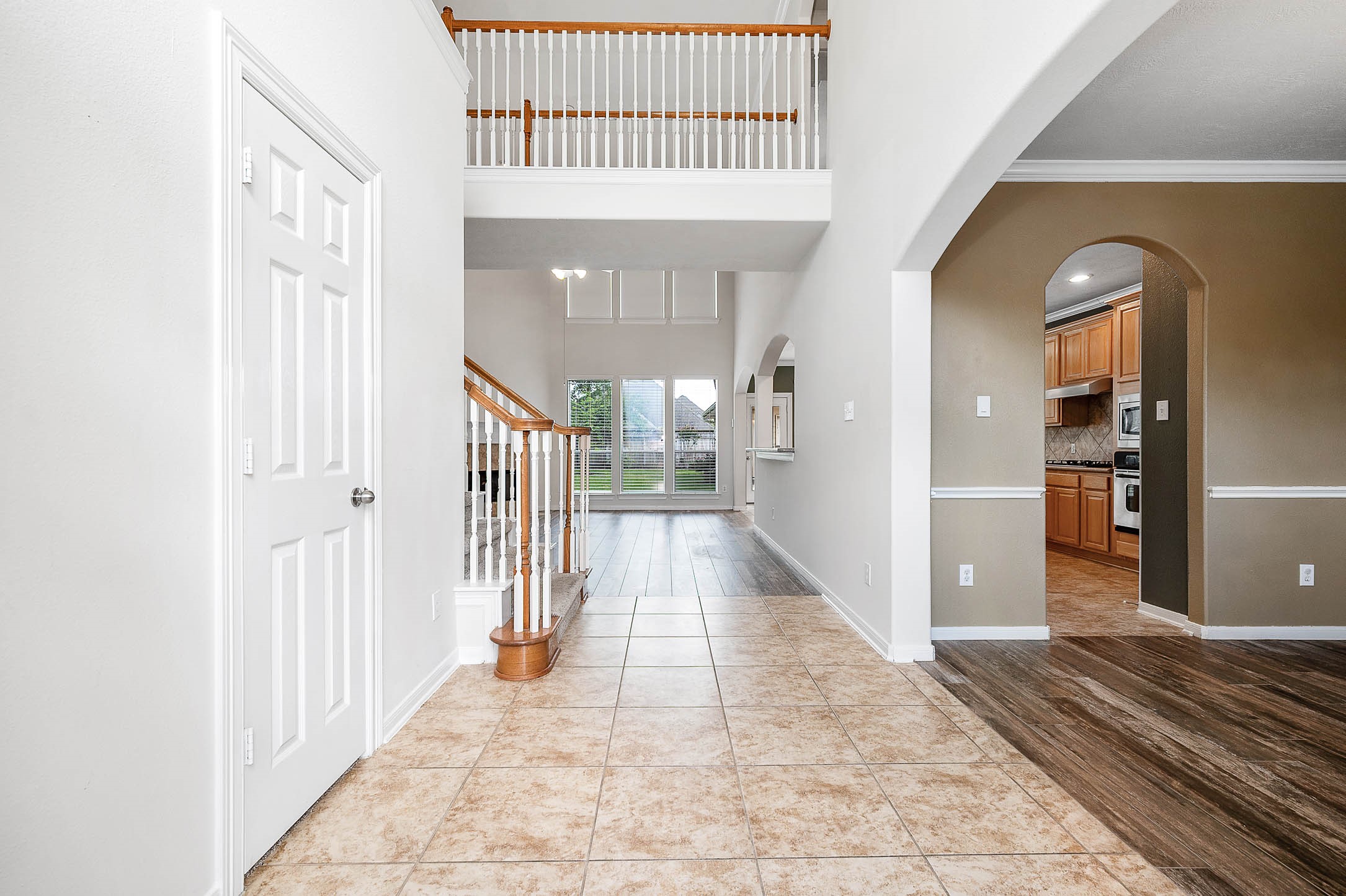 6411 Greencreek Meadows Lane Spring, TX 77379 - Photo 6 of 39 a view of a hallway with wooden floor and a living room