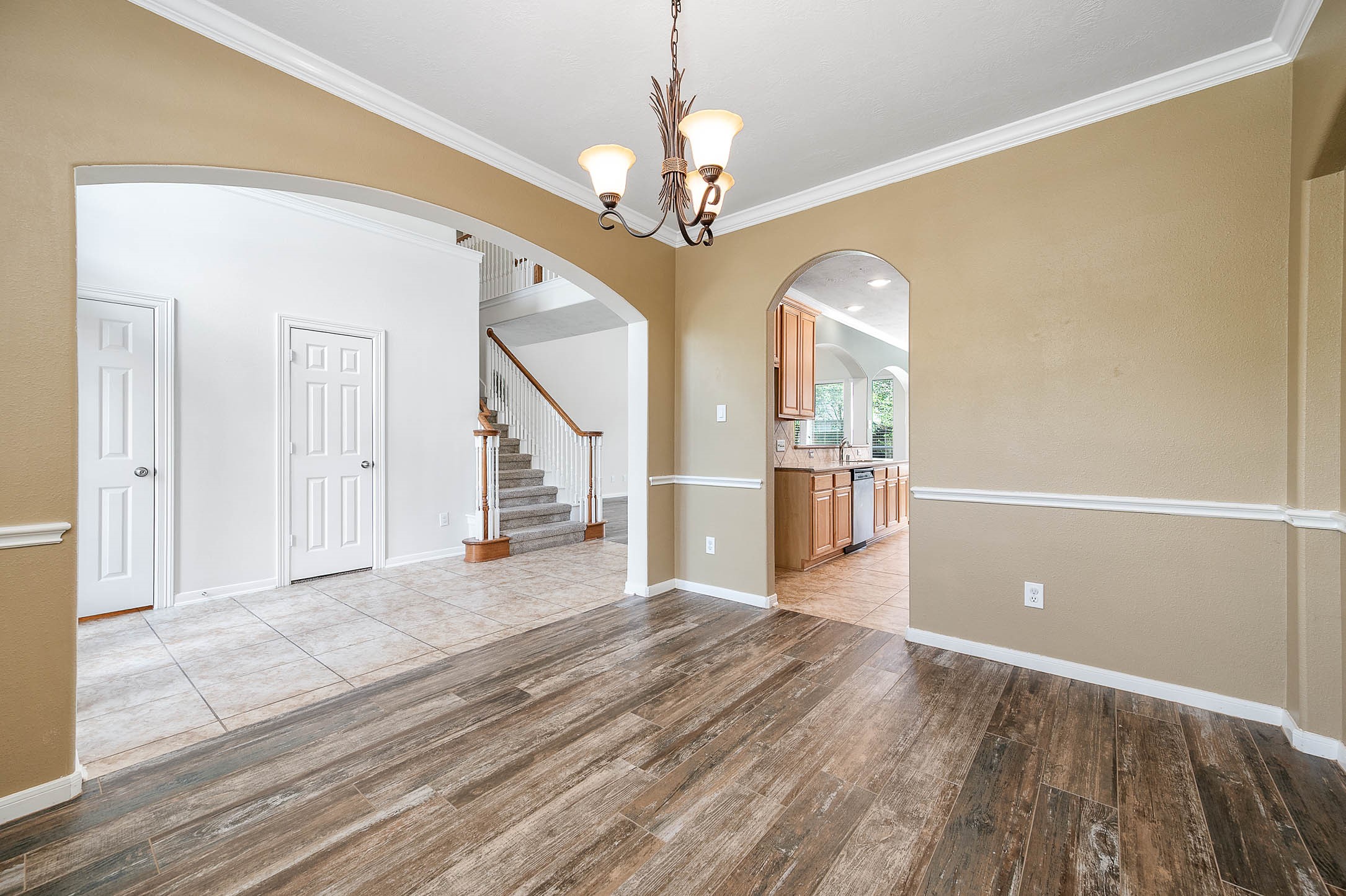 6411 Greencreek Meadows Lane Spring, TX 77379 - Photo 8 of 39 a view of a livingroom with wooden floor and a ceiling fan