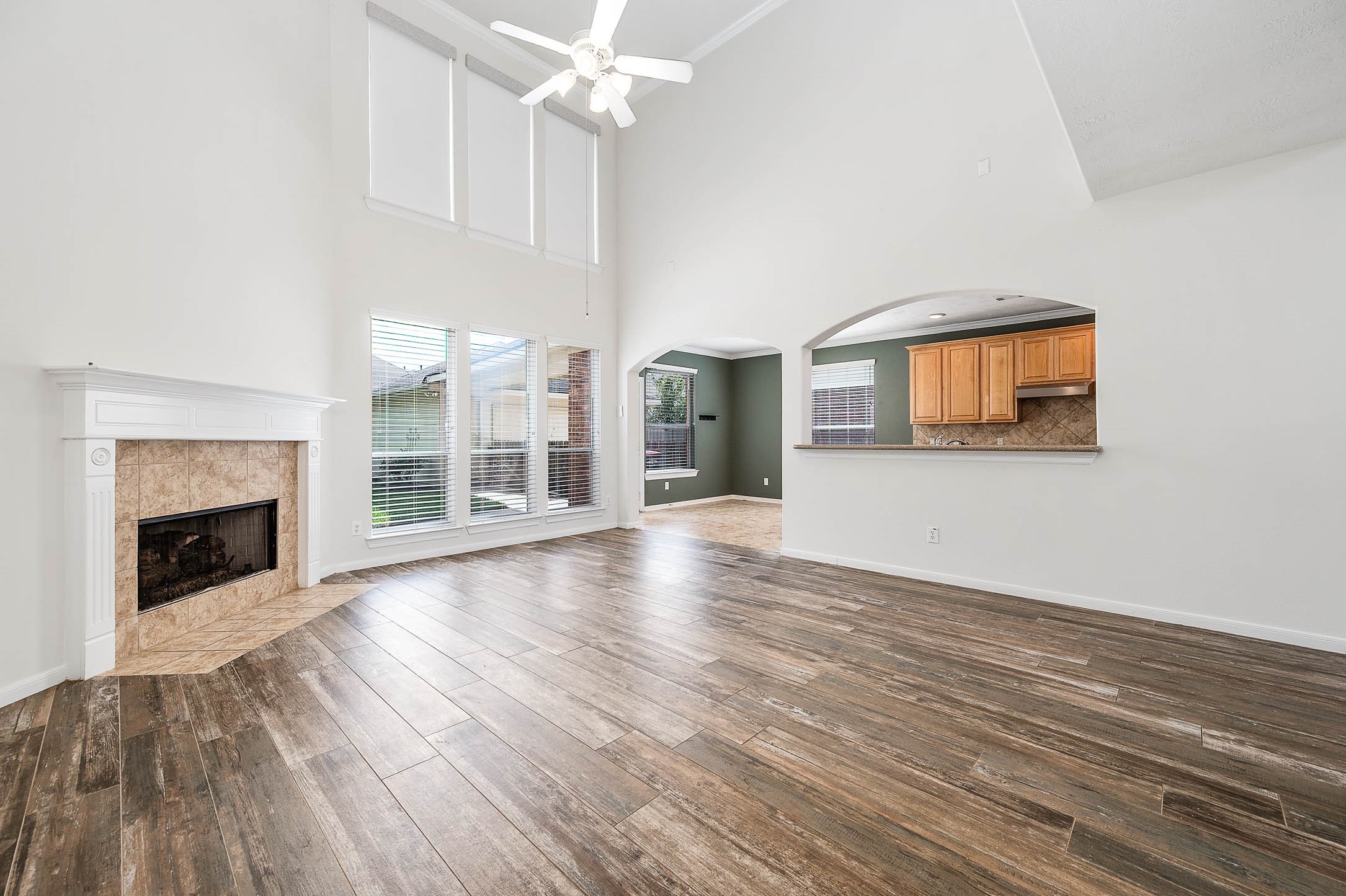 6411 Greencreek Meadows Lane Spring, TX 77379 - Photo 10 of 39 a view of an empty room with wooden floor fireplace and a window