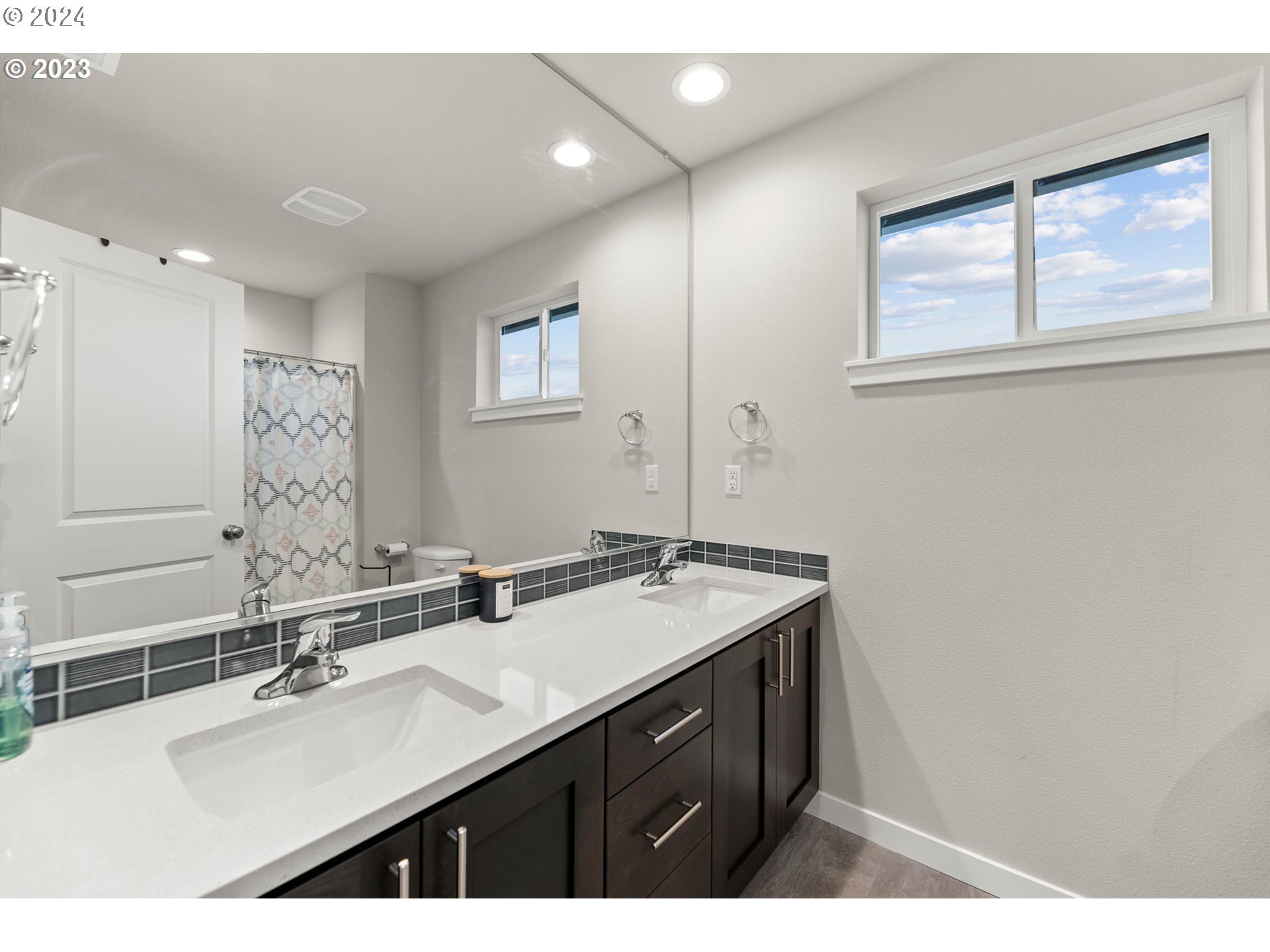 515 North 87th Court Ridgefield, WA 98642 - Photo 21 of 25 a bathroom with a sink vanity granite and a mirror