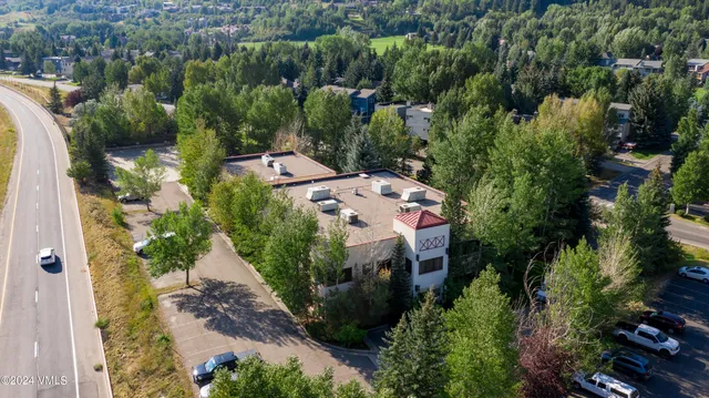 an aerial view of a house with a yard