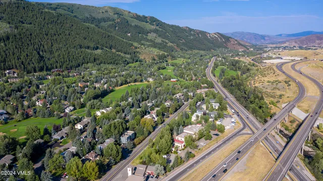 a view of a living room with furniture and floor to ceiling windows