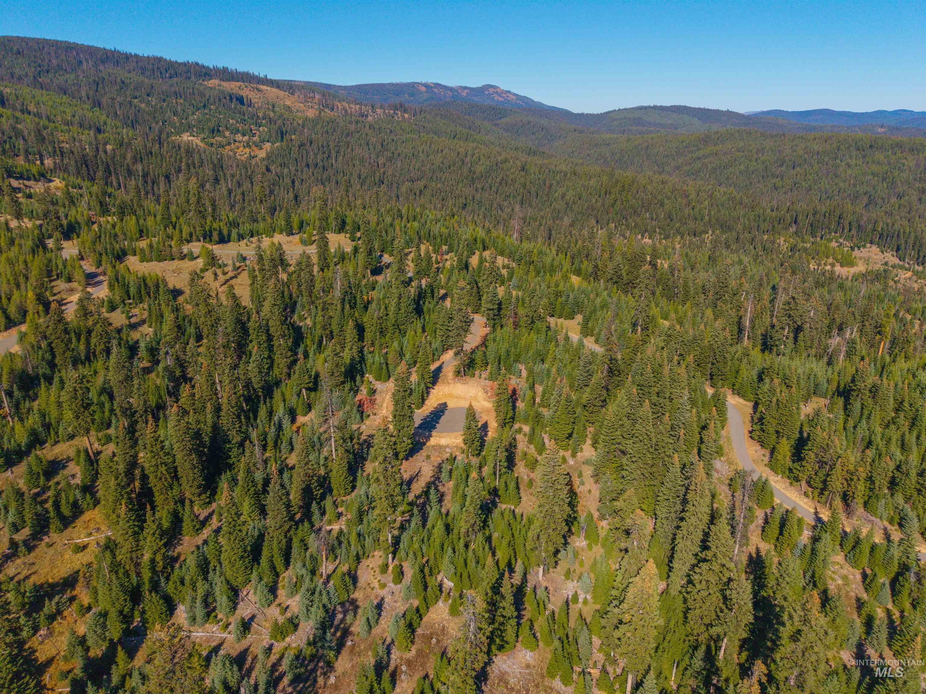4 Tree Farm Trails Road Elk City, ID 83525 - Photo 3 of 17 Aerial view of property's location with mountains and a heavily wooded area