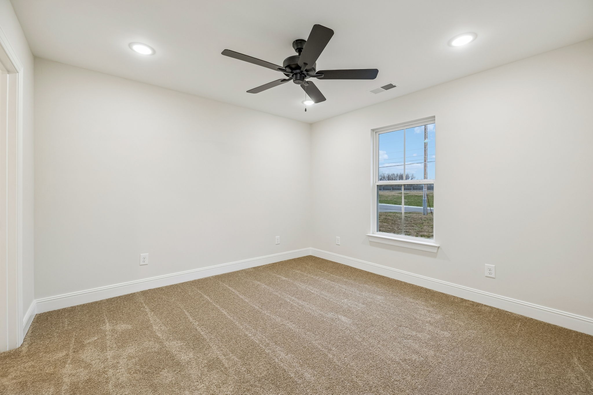 1073 Landing Lane Adams, TN 37010 - Photo 13 of 28 an empty room with a ceiling fan and window