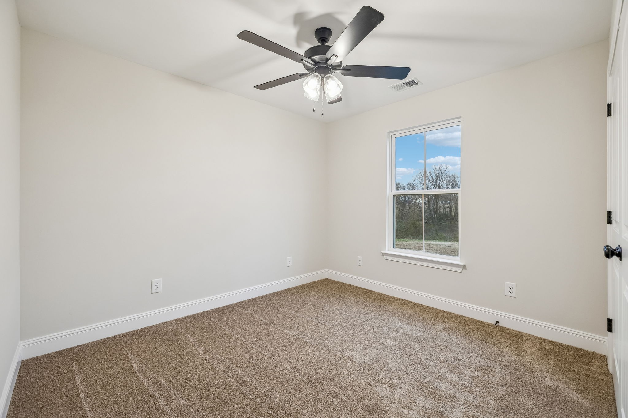 1073 Landing Lane Adams, TN 37010 - Photo 19 of 28 an empty room with a window and a fan
