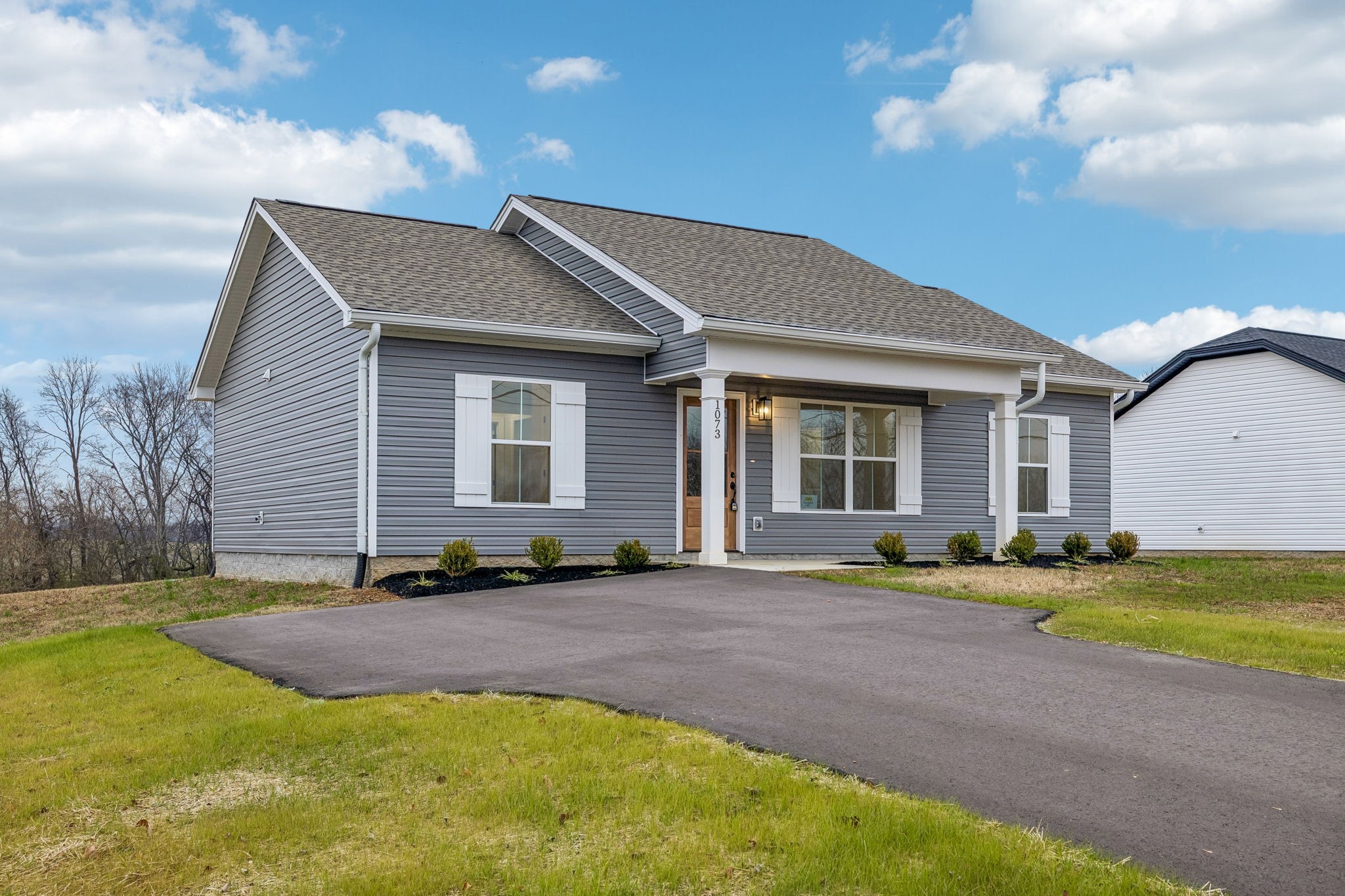 1073 Landing Lane Adams, TN 37010 - Photo 3 of 28 a front view of a house with a yard and garage