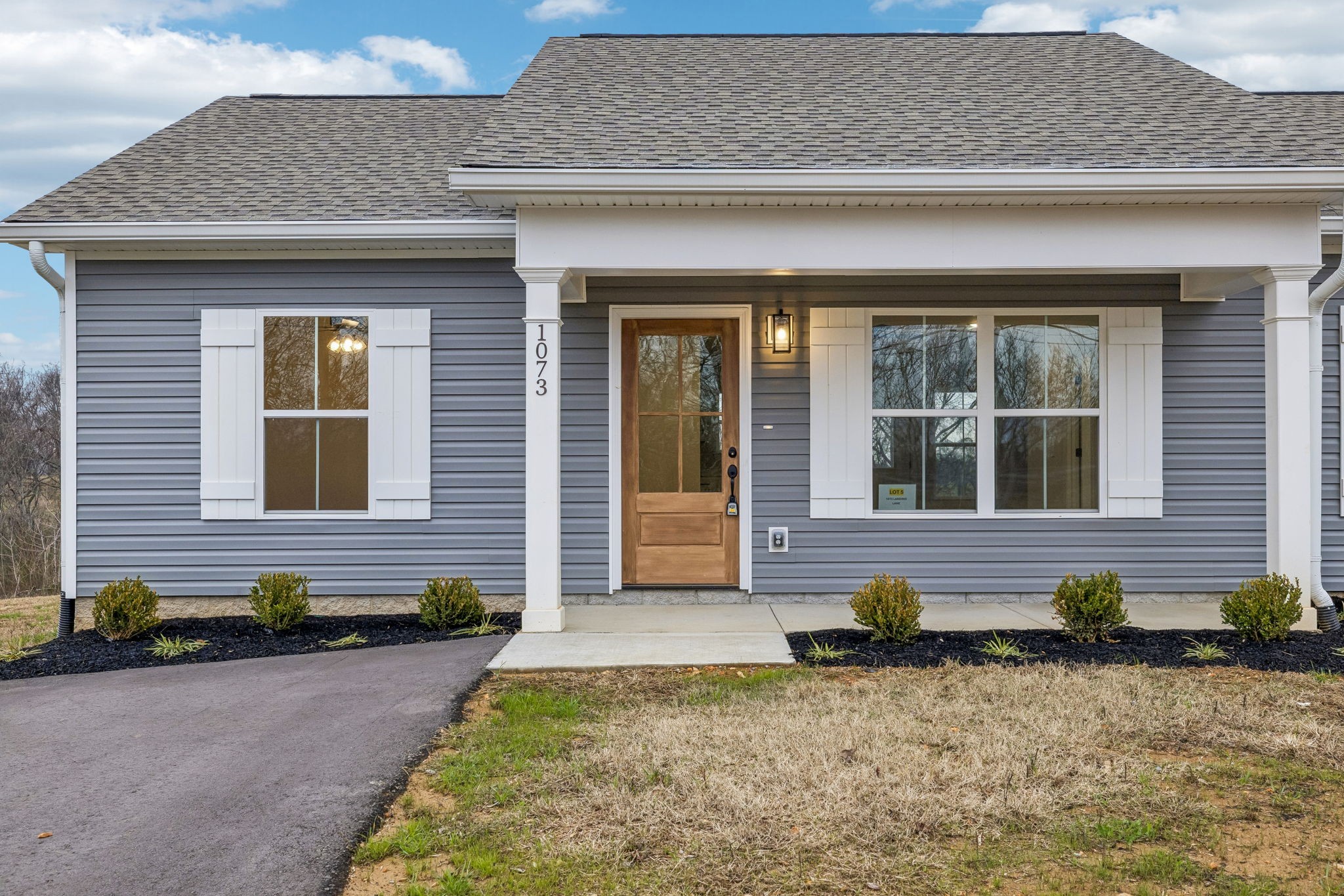 1073 Landing Lane Adams, TN 37010 - Photo 4 of 28 a front view of a house having yard