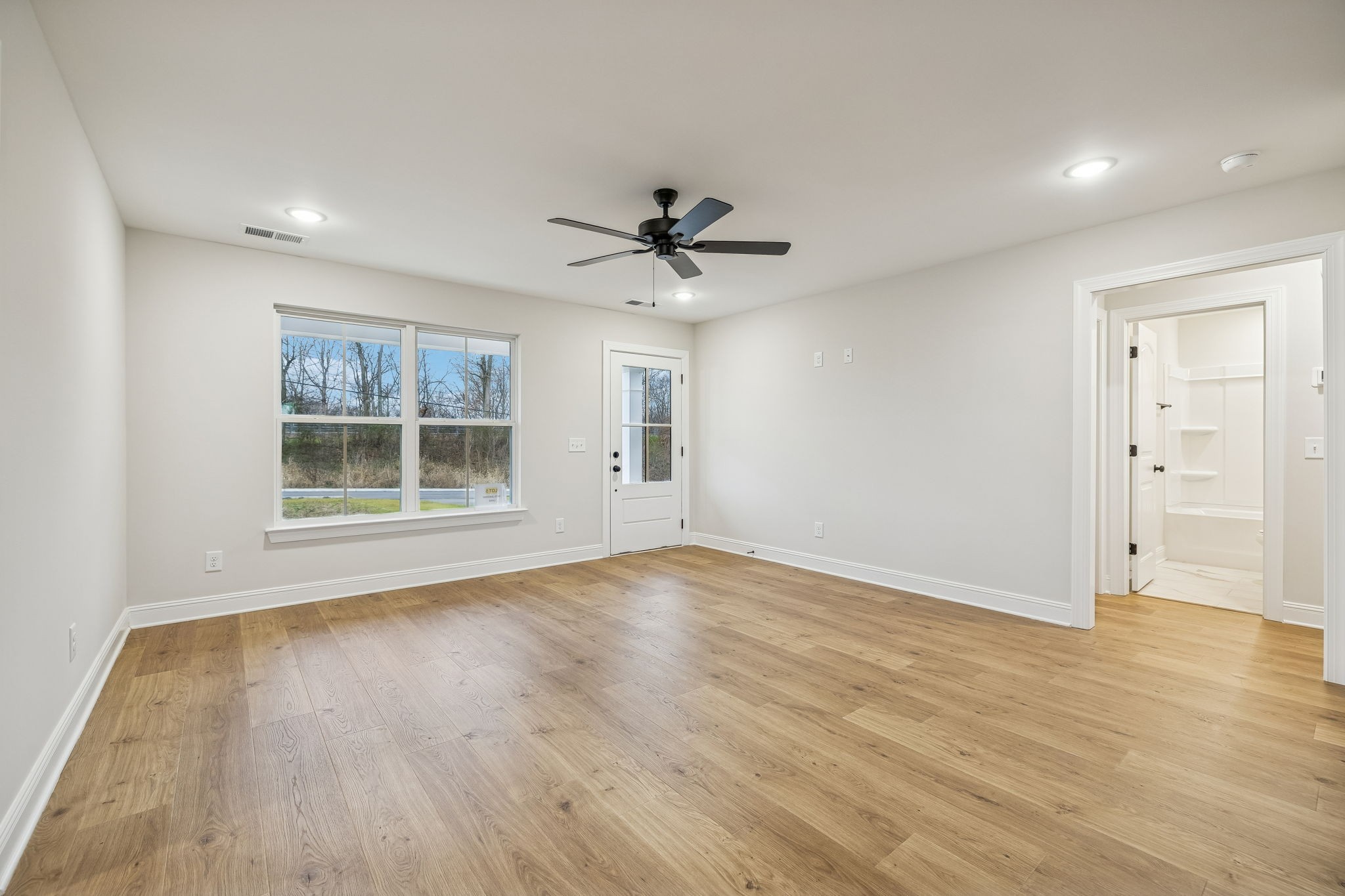 1073 Landing Lane Adams, TN 37010 - Photo 6 of 28 a view of an empty room with a window and wooden floor