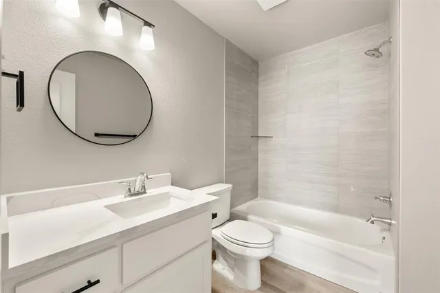 a bathroom with a sink a toilet and a mirror