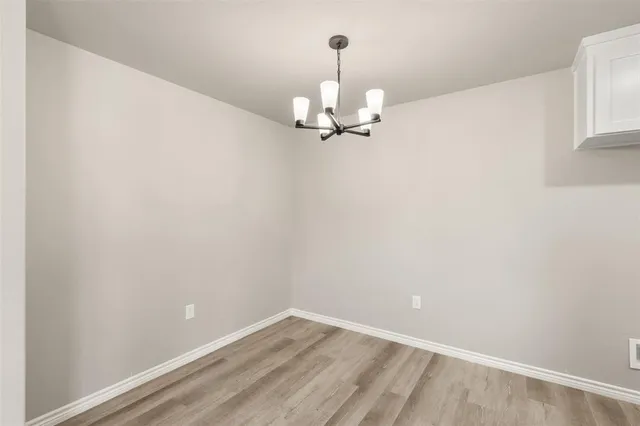 a view of a room with wooden floor cabinets and a ceiling fan