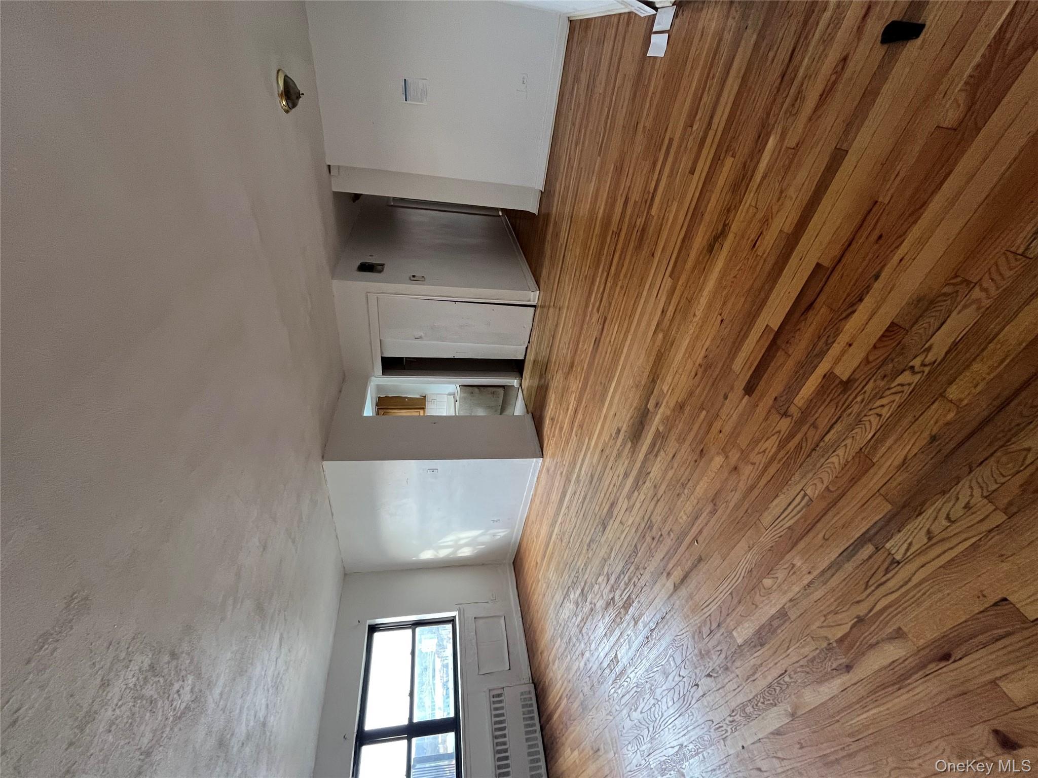 2545 Sedgwick Avenue, Unit 7B Bronx, NY 10468 - Photo 12 of 20 a view of an empty room with wooden floor and a window