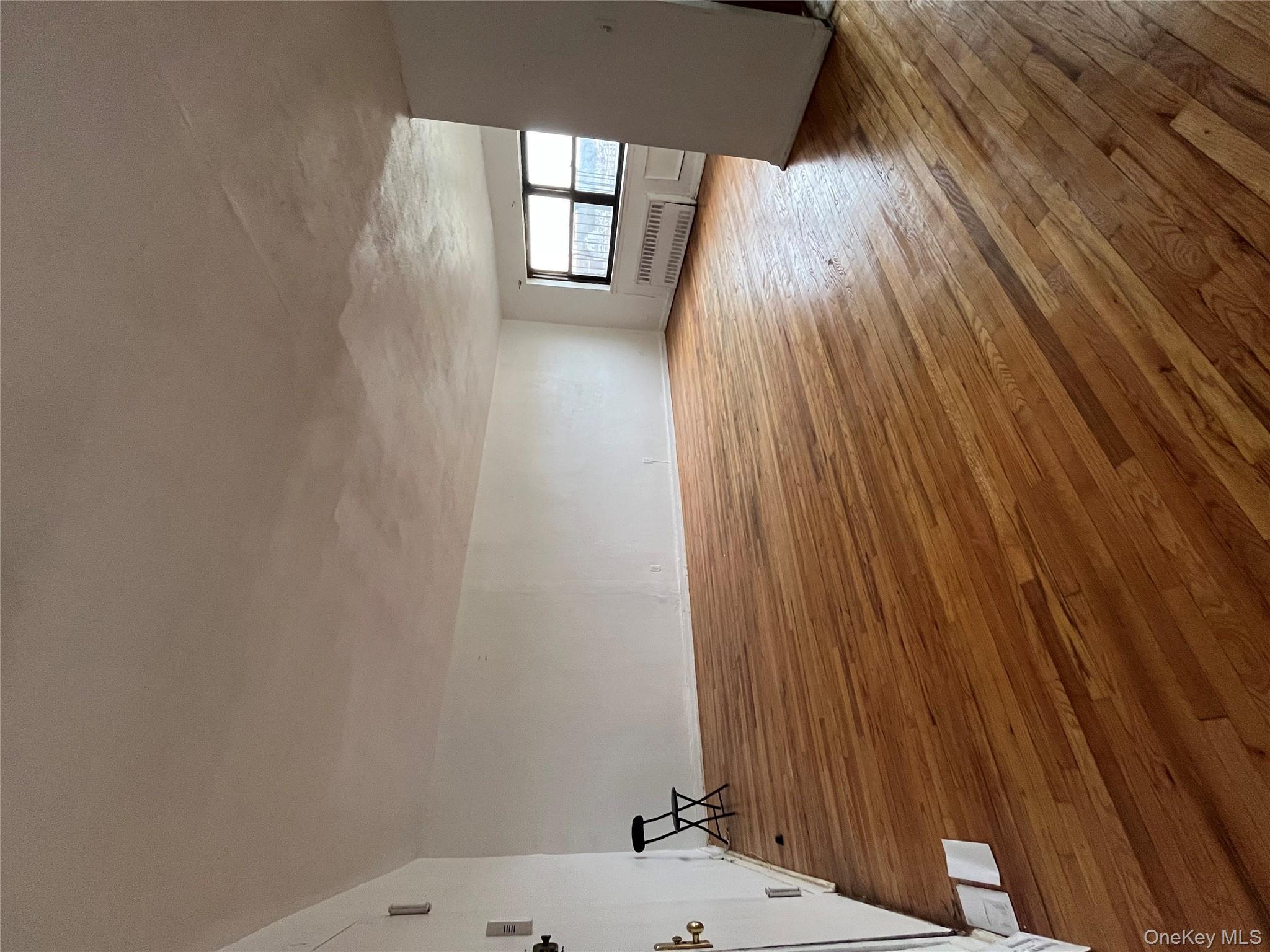 2545 Sedgwick Avenue, Unit 7B Bronx, NY 10468 - Photo 13 of 20 a view of empty room with wooden floor and fan