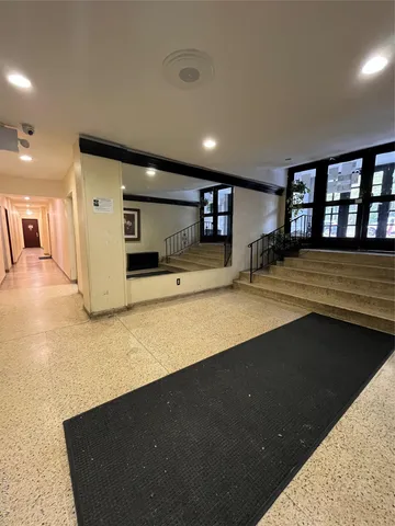 a view of a kitchen with a sink and dishwasher with wooden floor