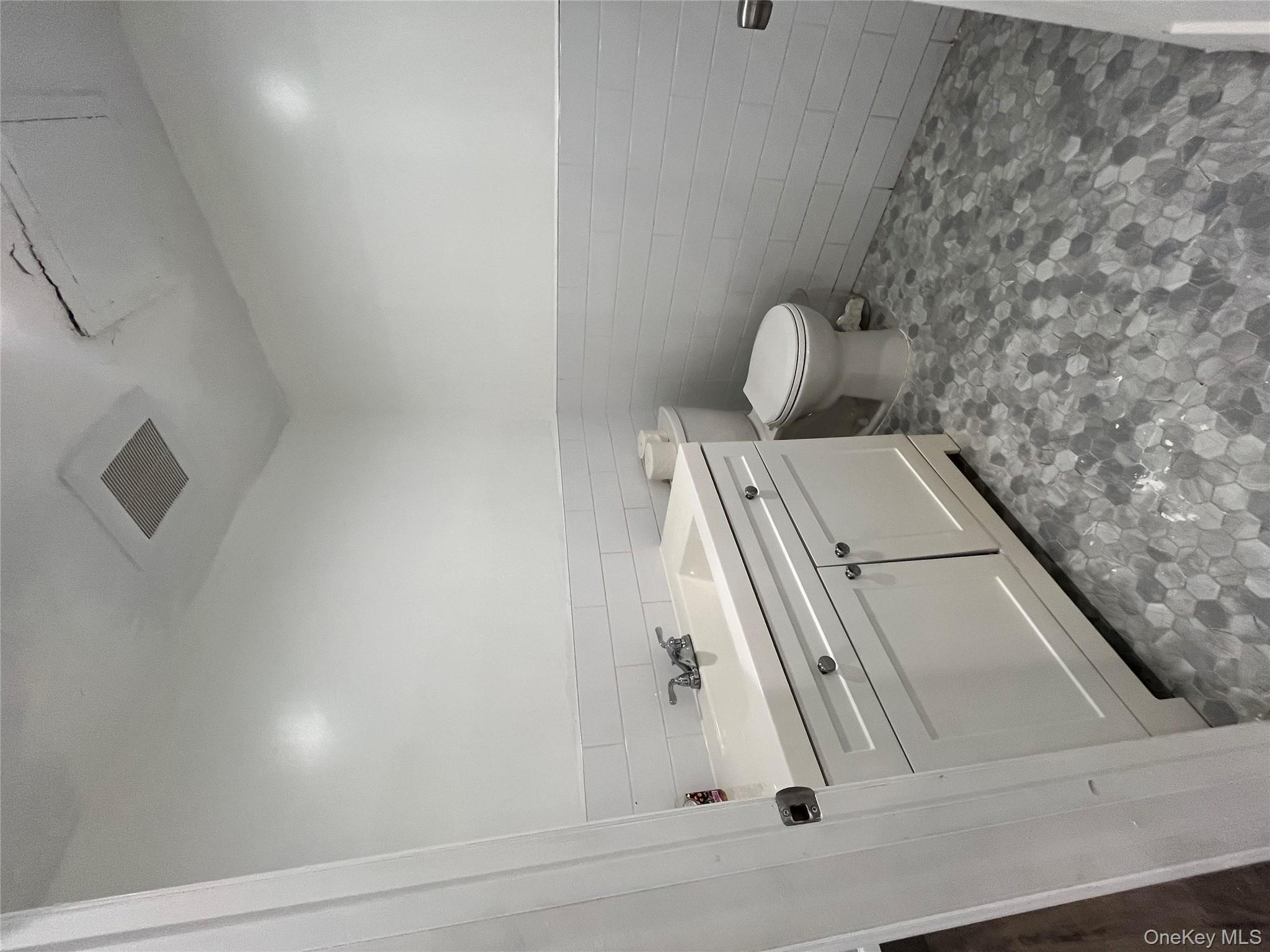 2545 Sedgwick Avenue, Unit 7B Bronx, NY 10468 - Photo 16 of 20 a bathroom with a sink toilet and a mirror