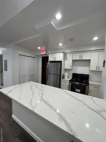 a kitchen with stainless steel appliances a refrigerator and a stove top oven